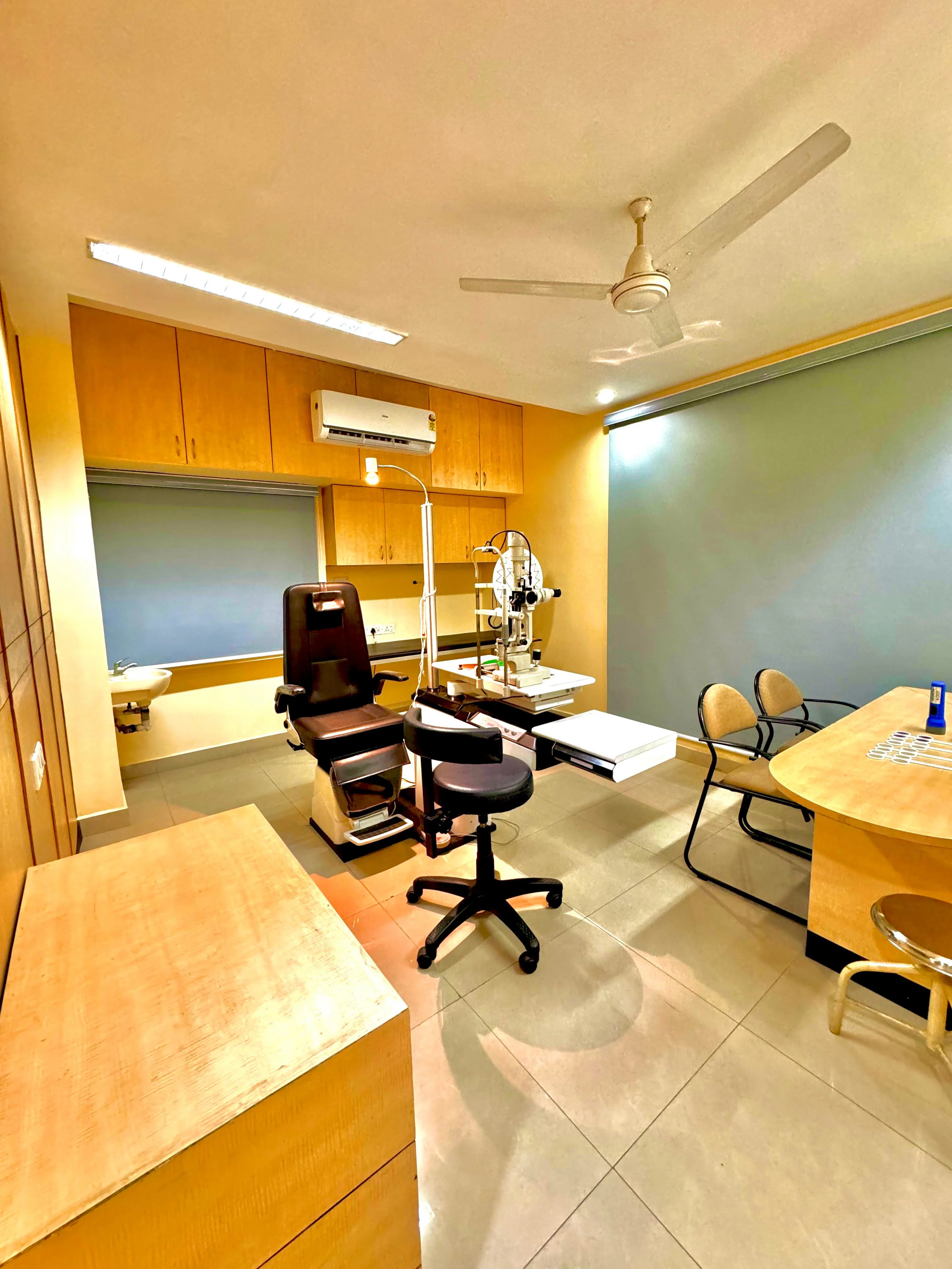 Caring Vision Therapy Anna Nagar Chennai – Consultation room with patient examination chair, slit lamp and doctor's desk