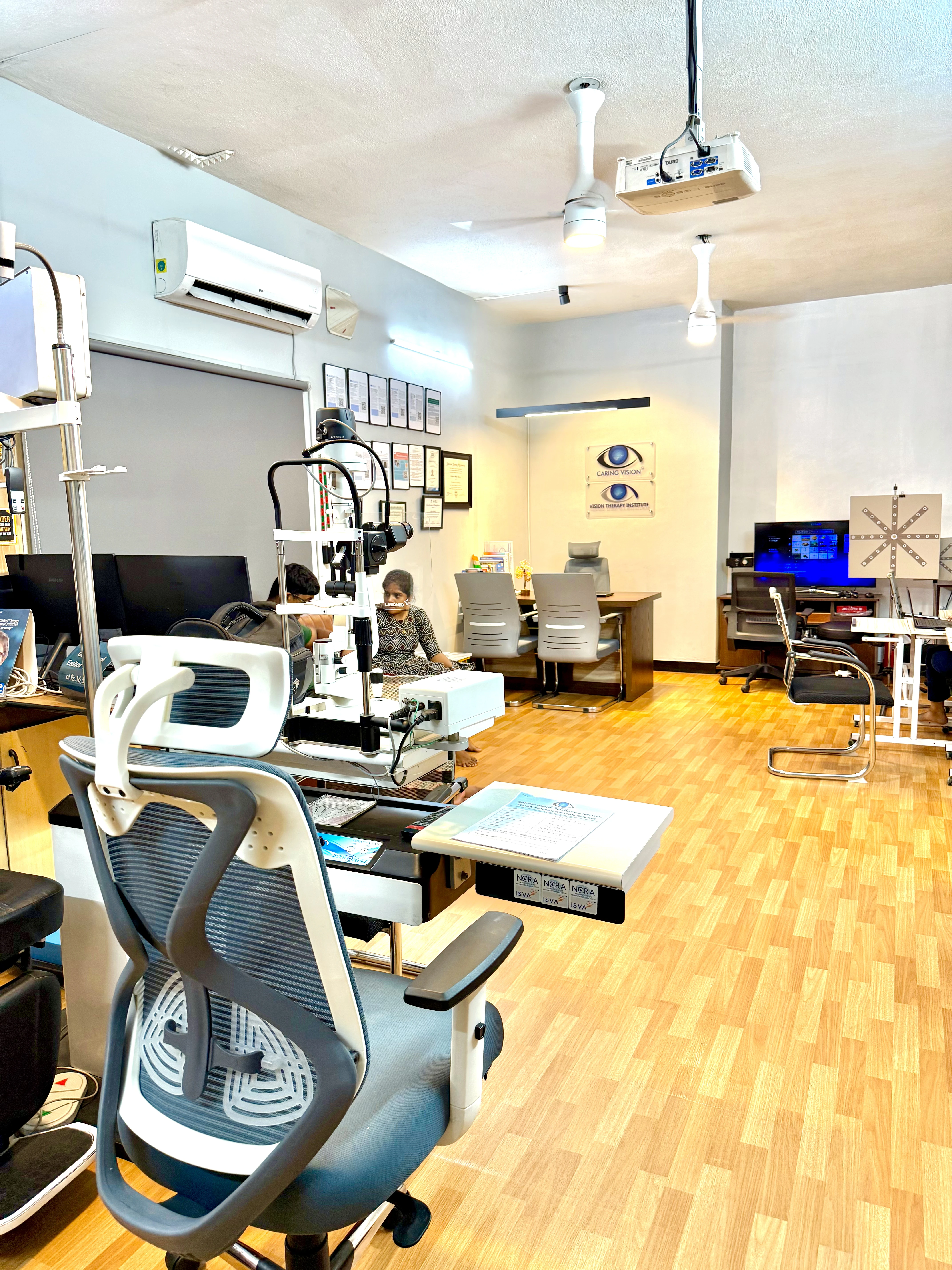 Caring Vision Therapy Ashok Nagar Chennai – Diagnostic and therapy floor with slit lamp, examination chairs and active therapy stations
