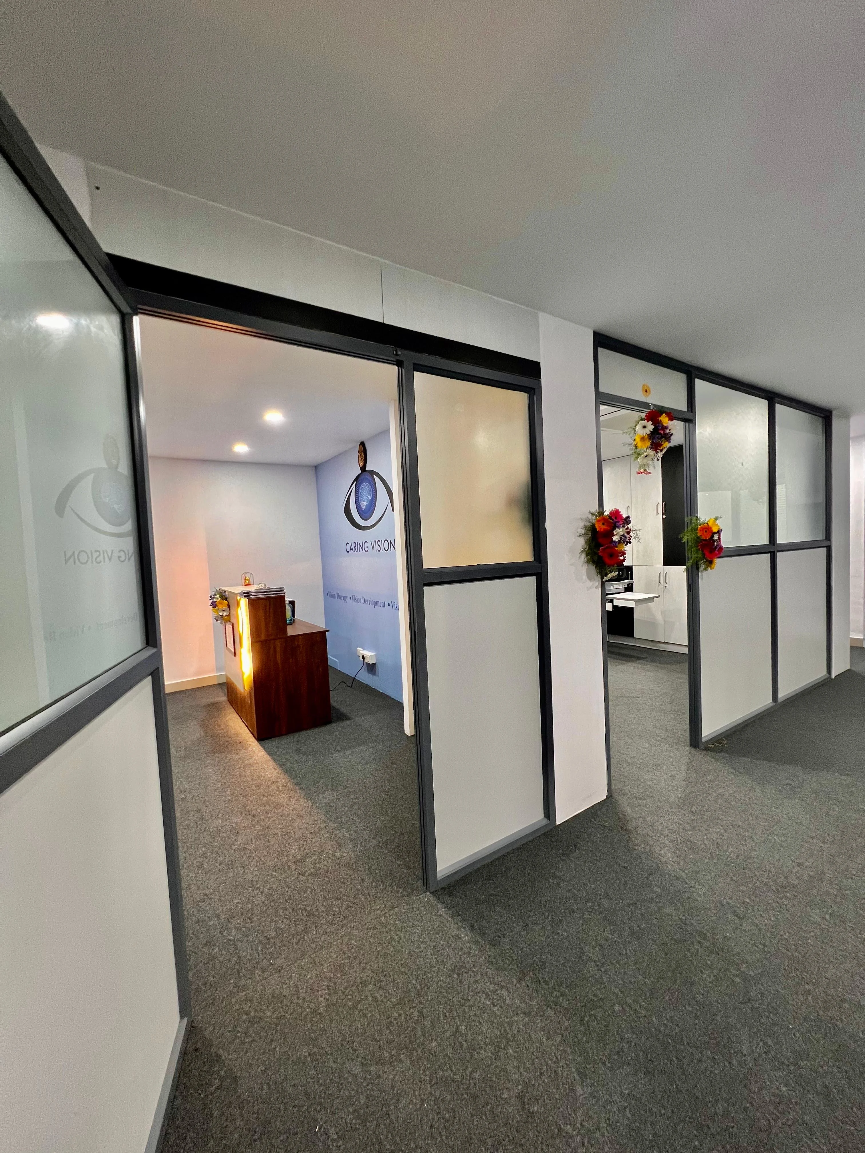 Caring Vision Therapy Hyderabad – Clinic interior entrance showing glass-partitioned consultation rooms and reception