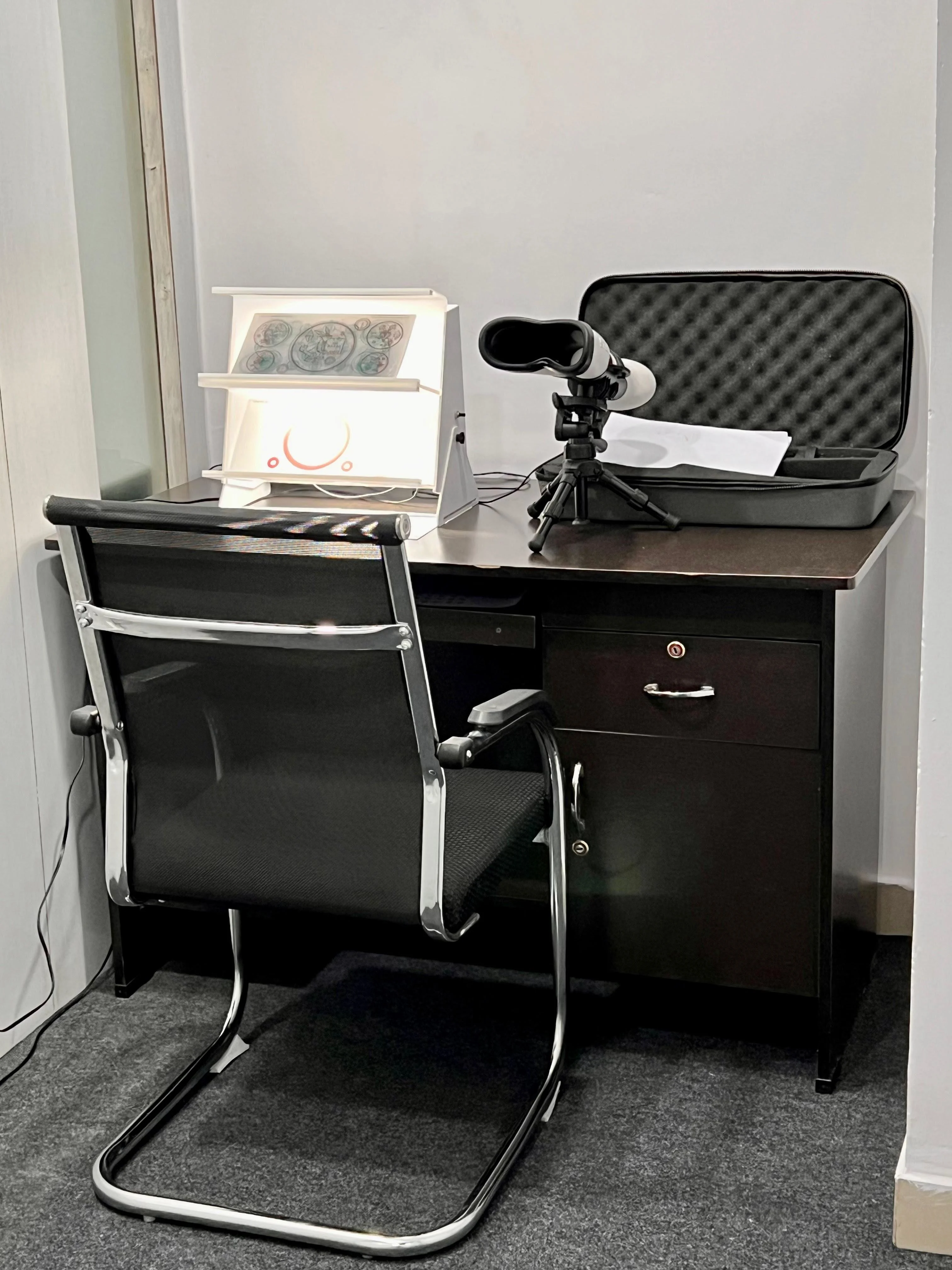 Caring Vision Therapy Hyderabad – Diagnostic equipment desk featuring synoptophore, light box and vision assessment instruments