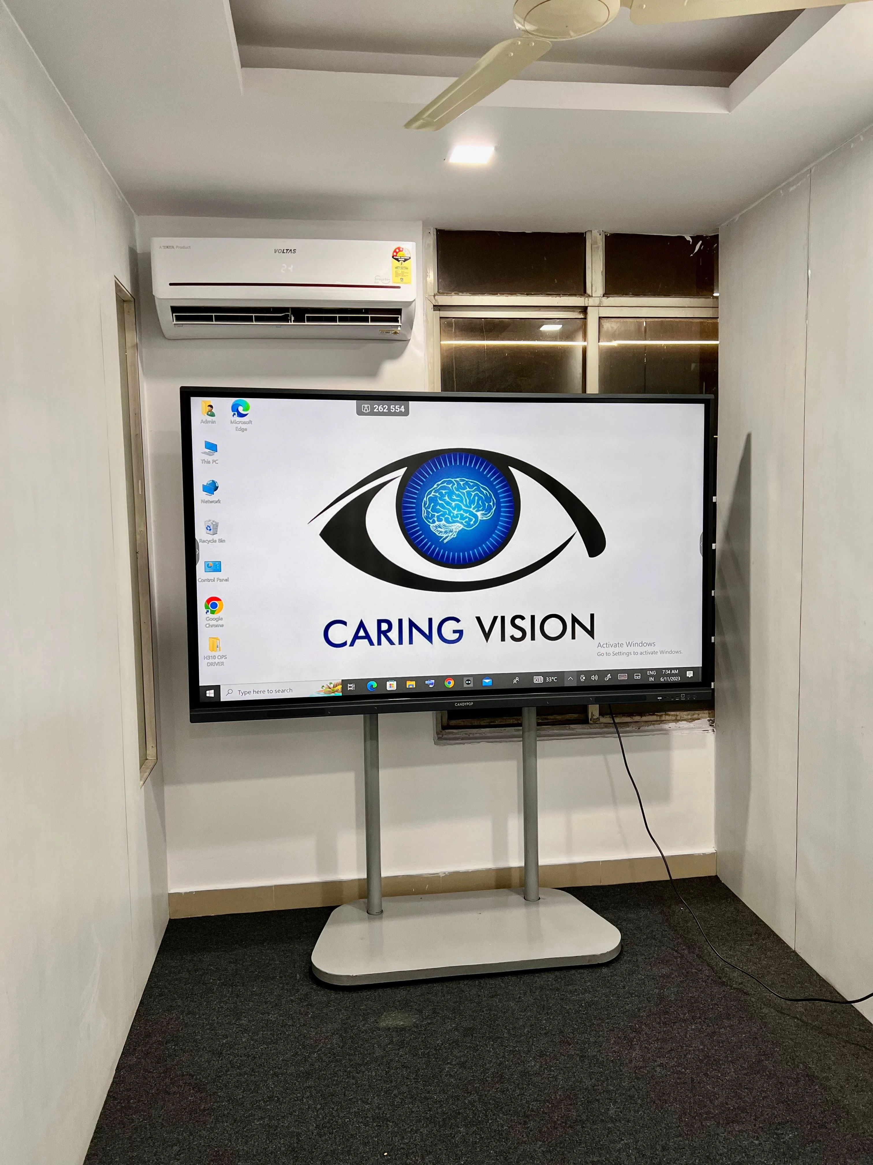 Caring Vision Therapy Hyderabad – Vision therapy room with large Caring Vision branded interactive display screen